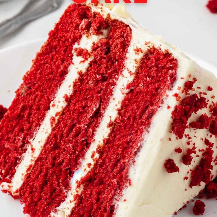 A slice of 3 layer red velvet cake frosted with cream cheese frosting, served on a small white cake plate. And overlay text that says "classic red velvet cake"