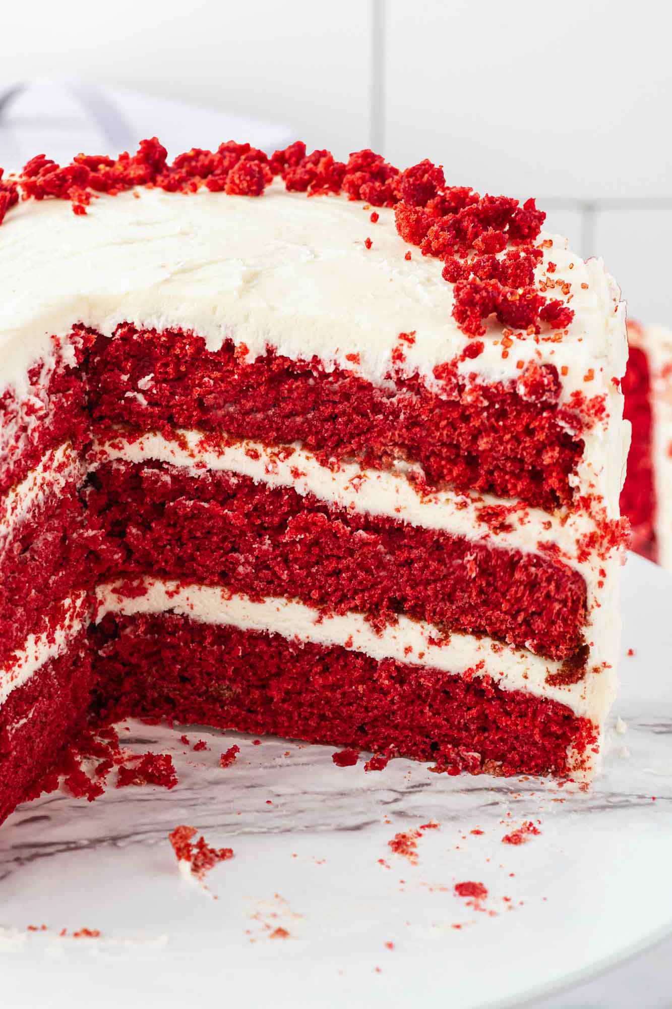 Sliced whole red velvet cake to show the layers
