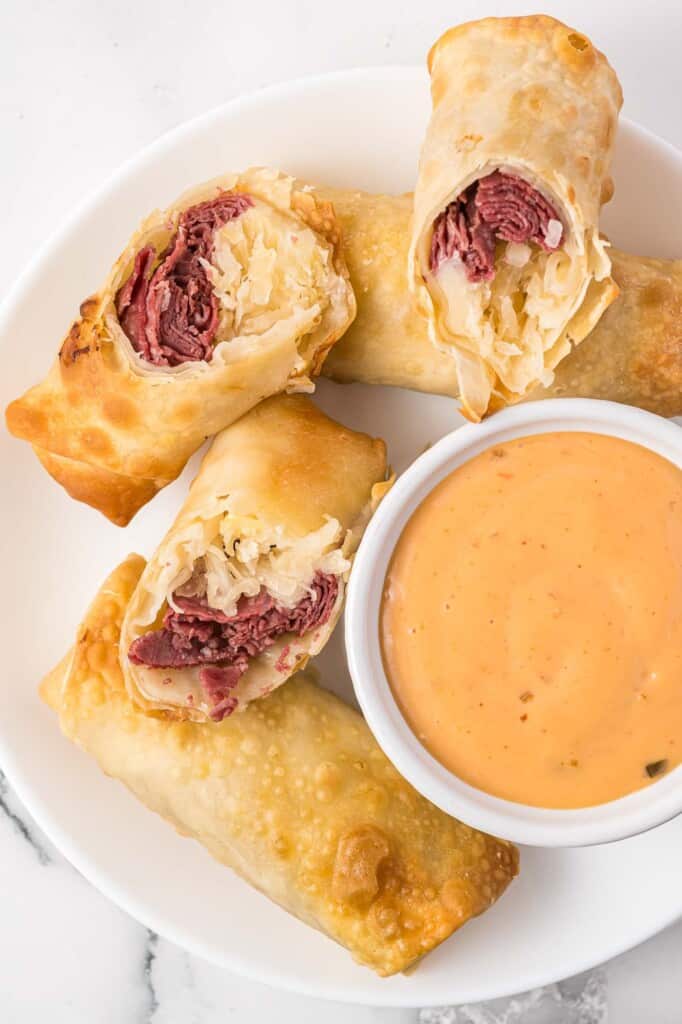 Reuben egg rolls served with Russian dressing on the side