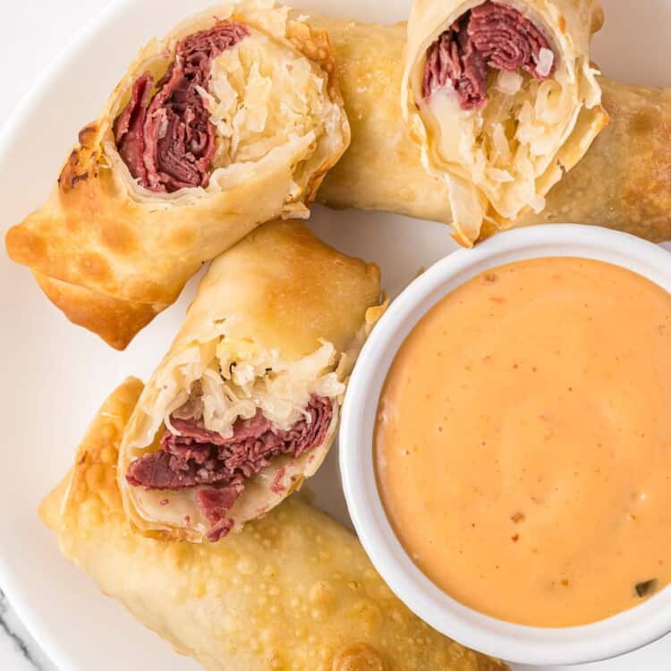 Reuben egg rolls served with Russian dressing on the side