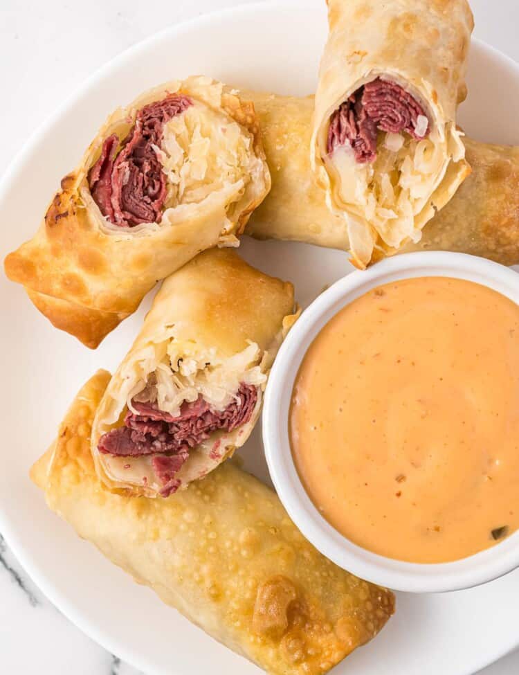 Reuben egg rolls served with Russian dressing on the side