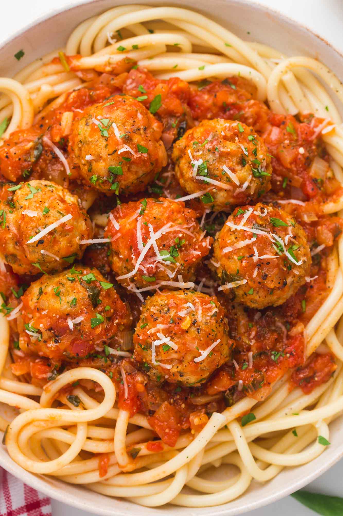Overhead shot of turkey meatballs served with sauce and spaghetti