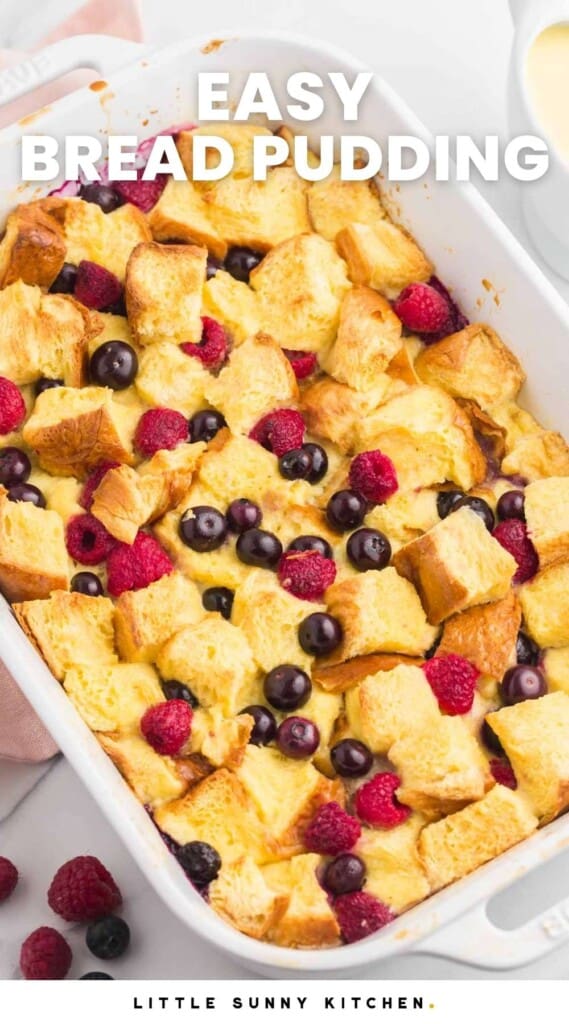 Overhead shot of berry bread pudding in a white baking dish. And overlay text that says "easy bread pudding"