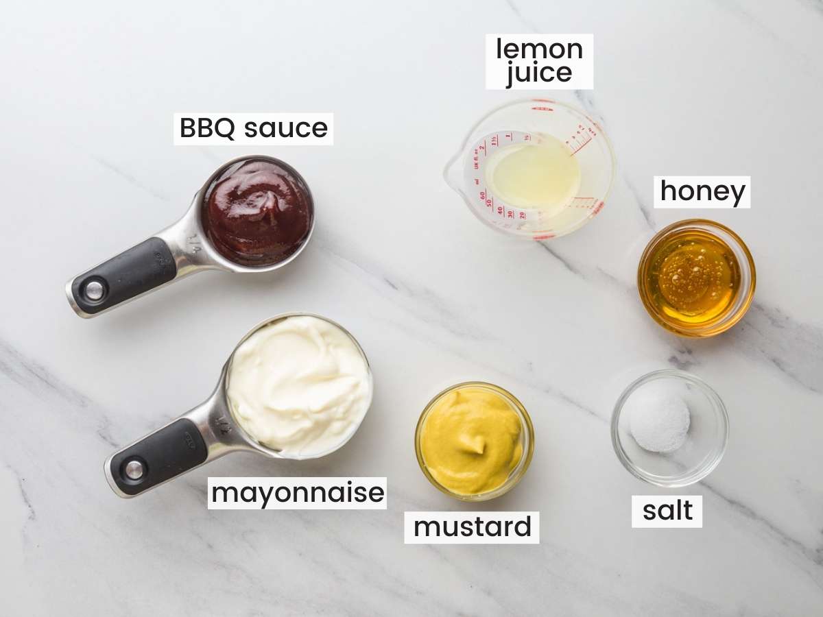 The Ingredients for Chick Fil A Sauce in separate bowls on a marble countertop