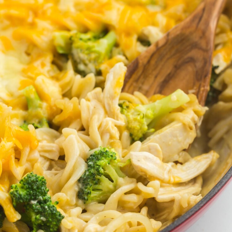 Creamy chicken broccoli casserole in a casserole dish with a serving spoon