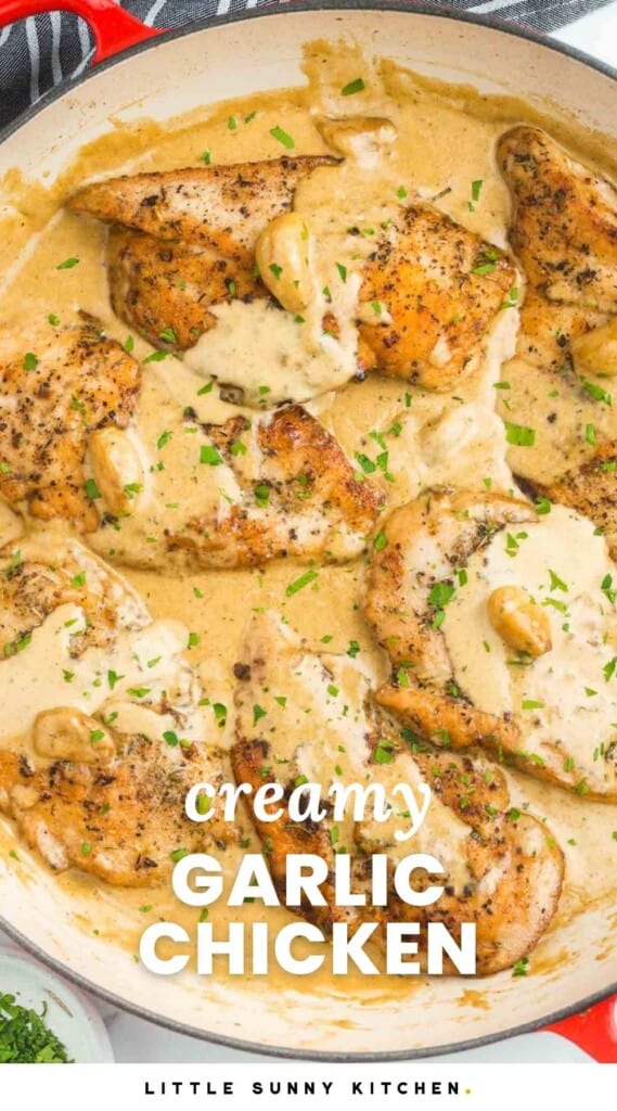 a white enameled skillet filled with creamy garlic chicken. text on top of photo says creamy garlic chicken in white letters