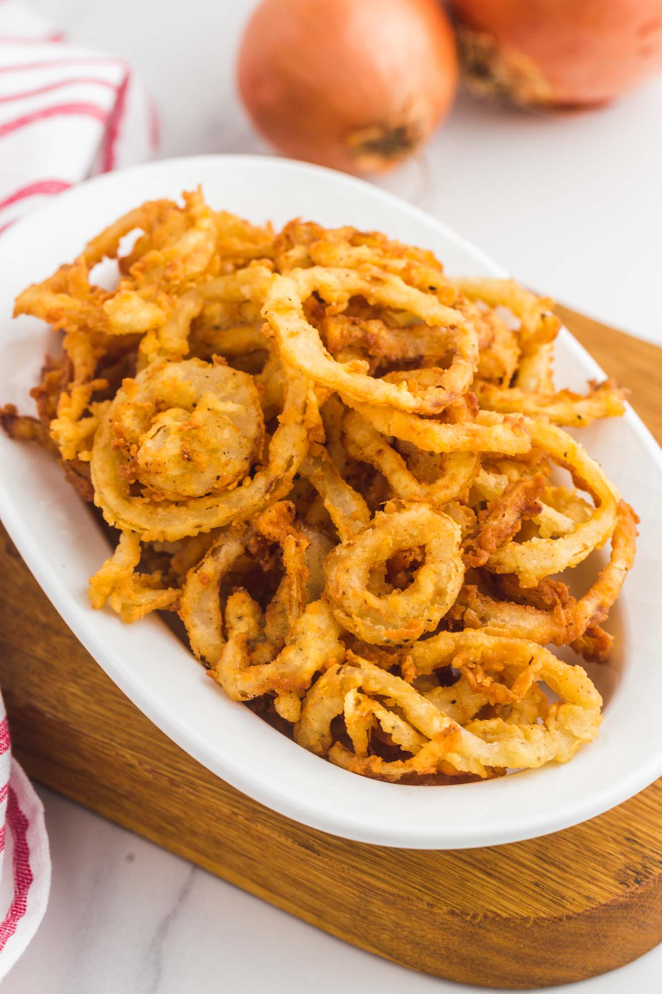 Crispy fried onions served in a small oval bowl
