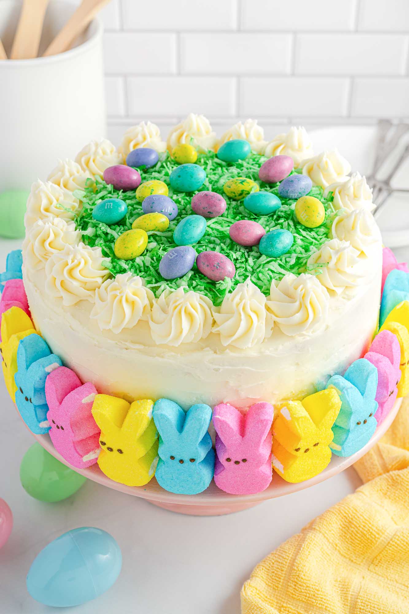 Easter Peep cake decorated with peeps, green coconut grass and buttercream.