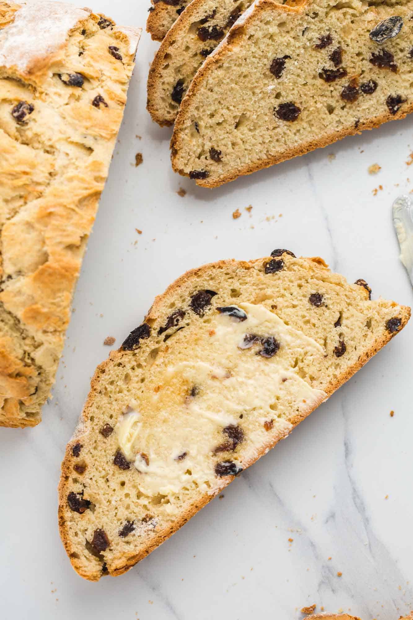 A slice of irish soda bread with softened butter