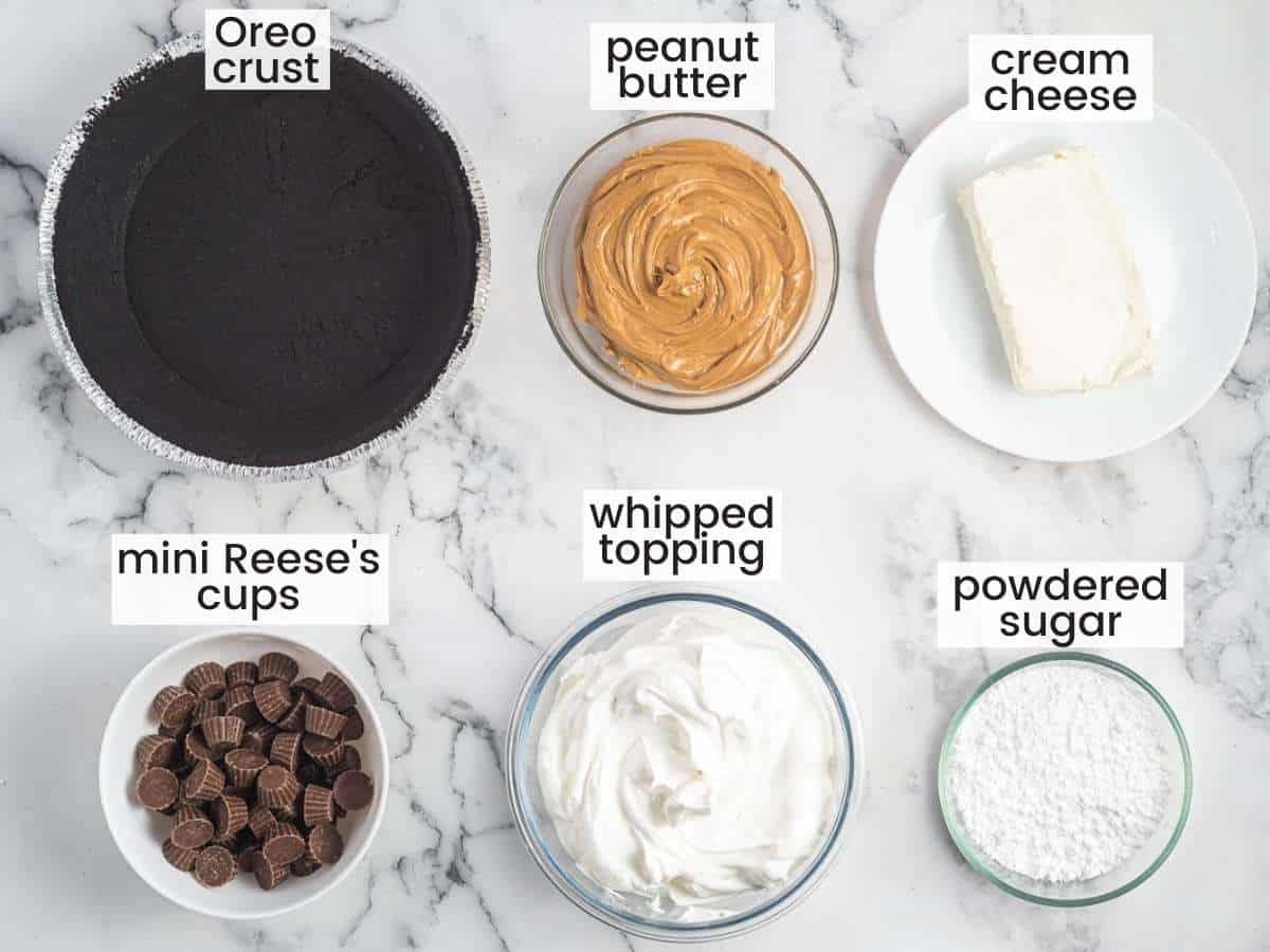 The ingredients for no bake peanut butter pie in separate bowls on a marble counter. 