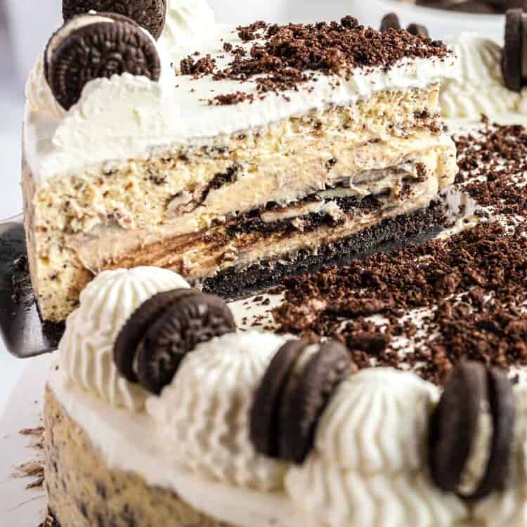 Taking a slice of baked Oreo cheesecake from the whole cake using a server
