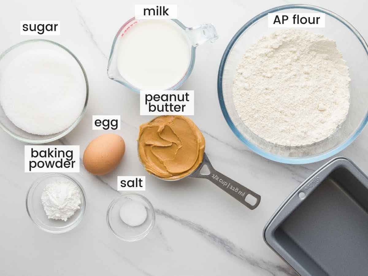 Ingredients needed to make peanut butter bread and a loaf pan