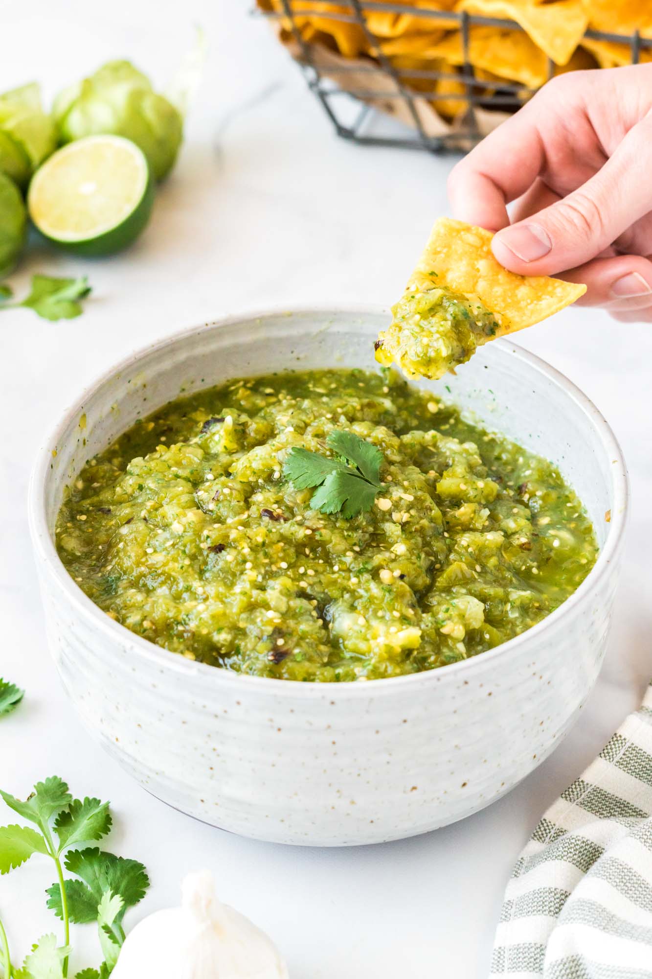 Dipping a chip in salsa verde