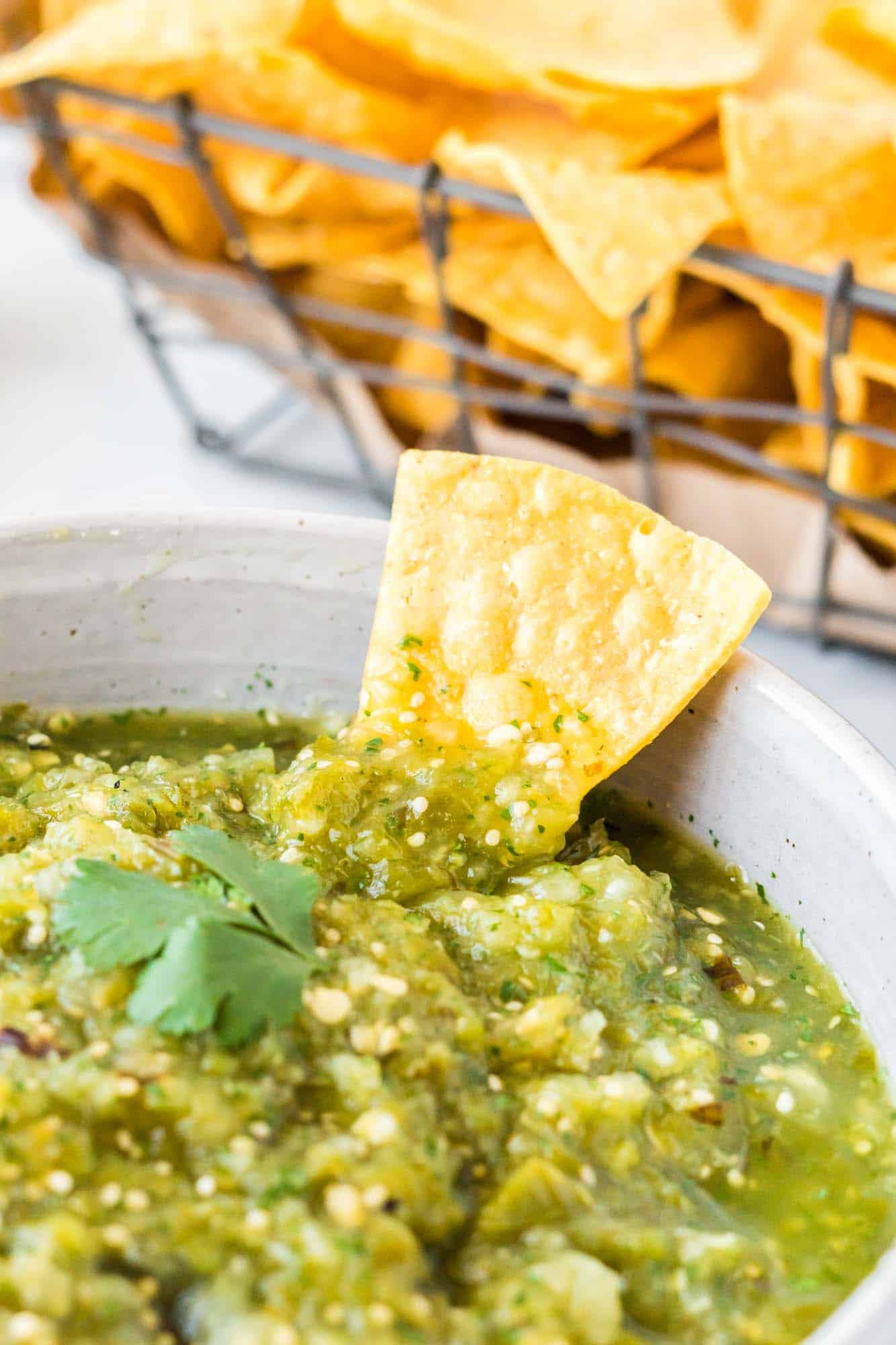Close up shot of salsa verde and a chip