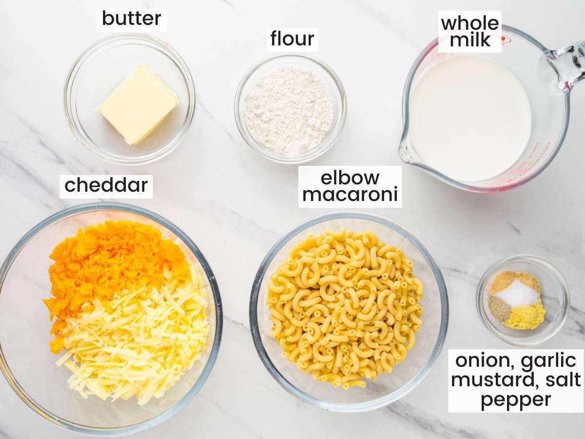 the ingredients for homemade stovetop mac and cheese, all measured into separate bowls, sitting on a counter. 