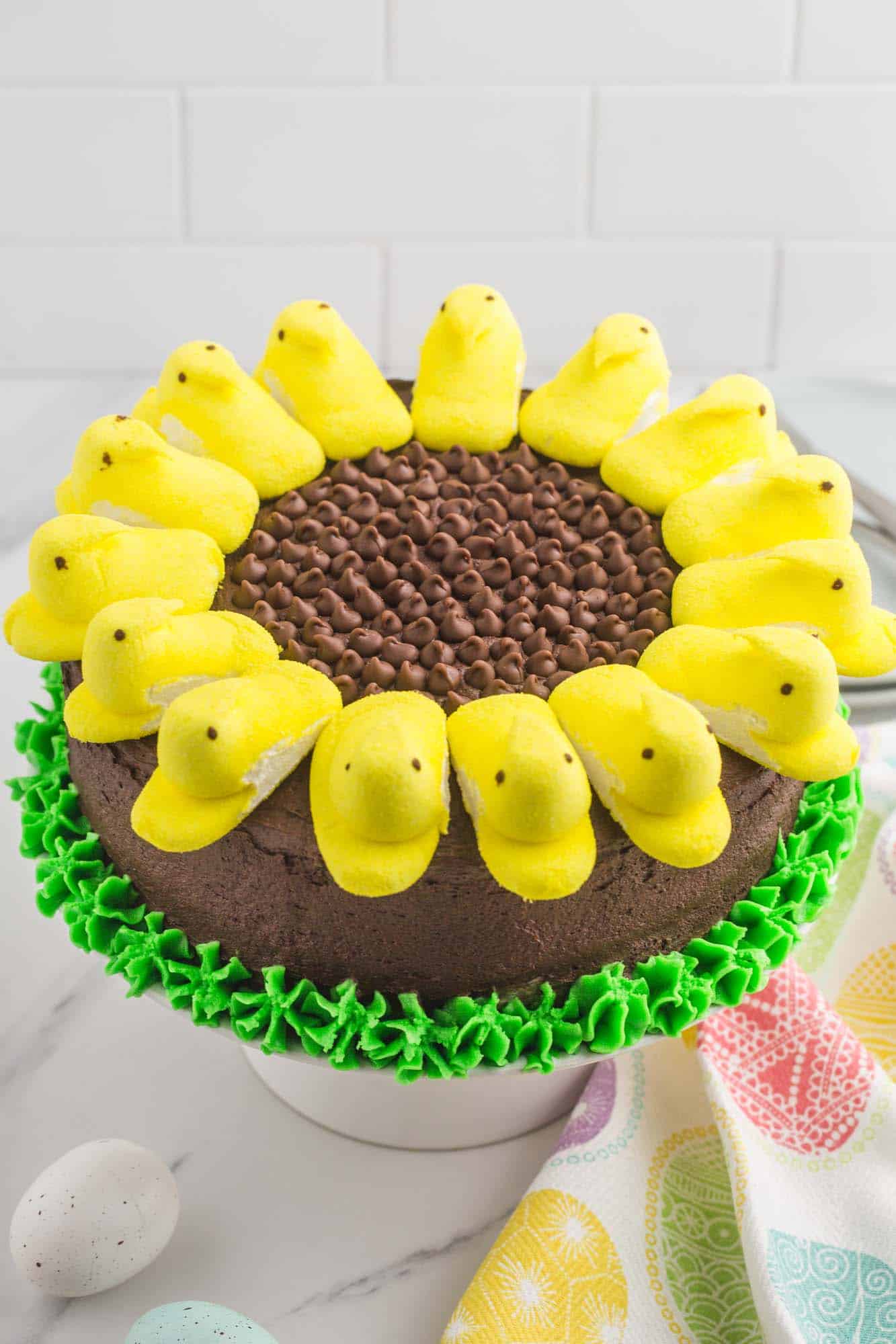 Chocolate cake decorated to look like a sunflower with yellow peeps