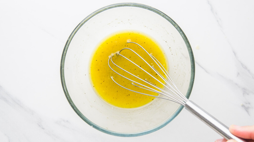 top down view of dressing being whisked in a small glass bowl