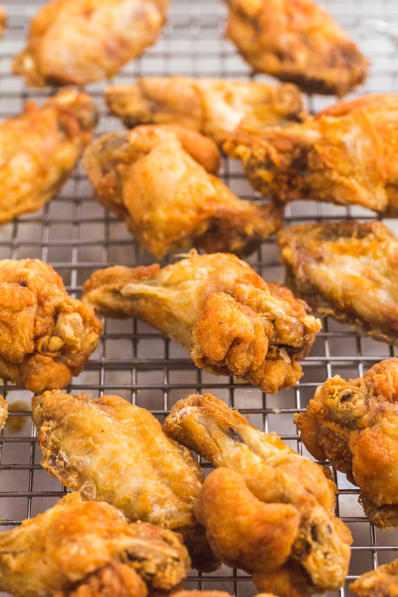 crispy cooked chicken wings on a wire cooling rack