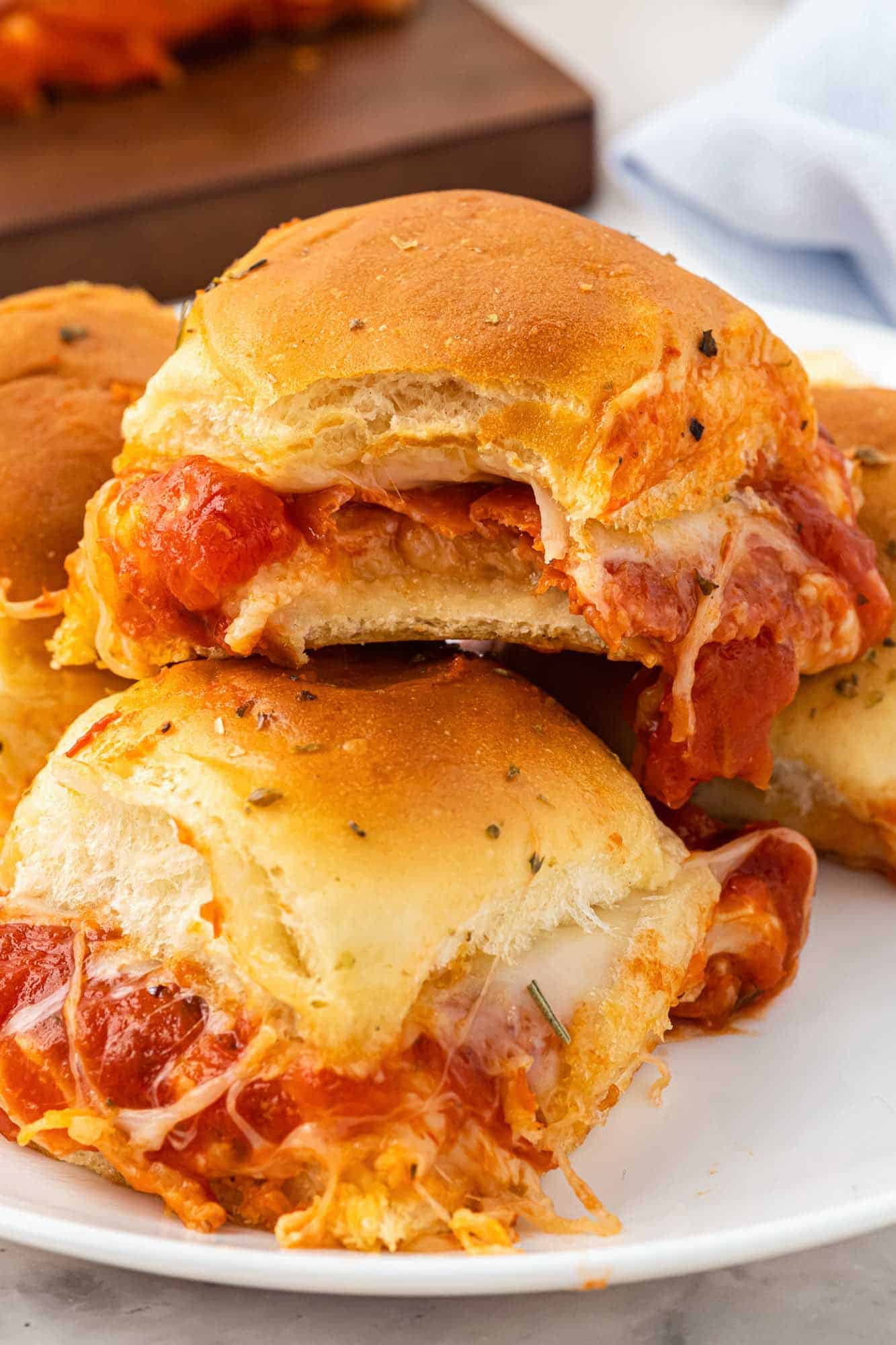 pizza sliders, stacked on a plate.