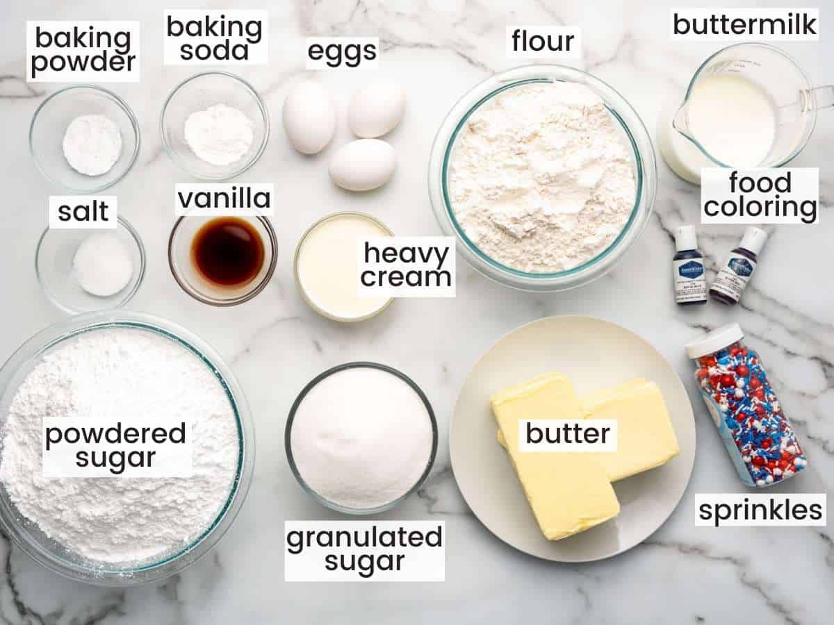 The ingredients for making a vanilla cake decorated for the 4th of july, all measured into separate bowls, viewed from above