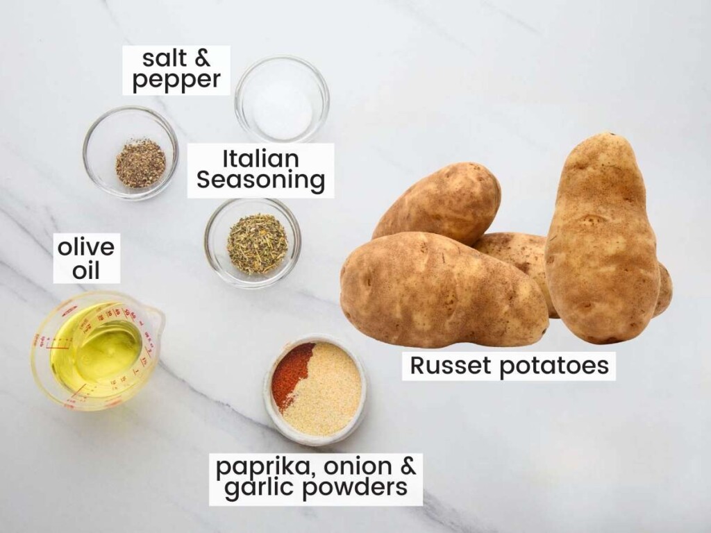 The ingredients for oven baked potato wedges on a counter