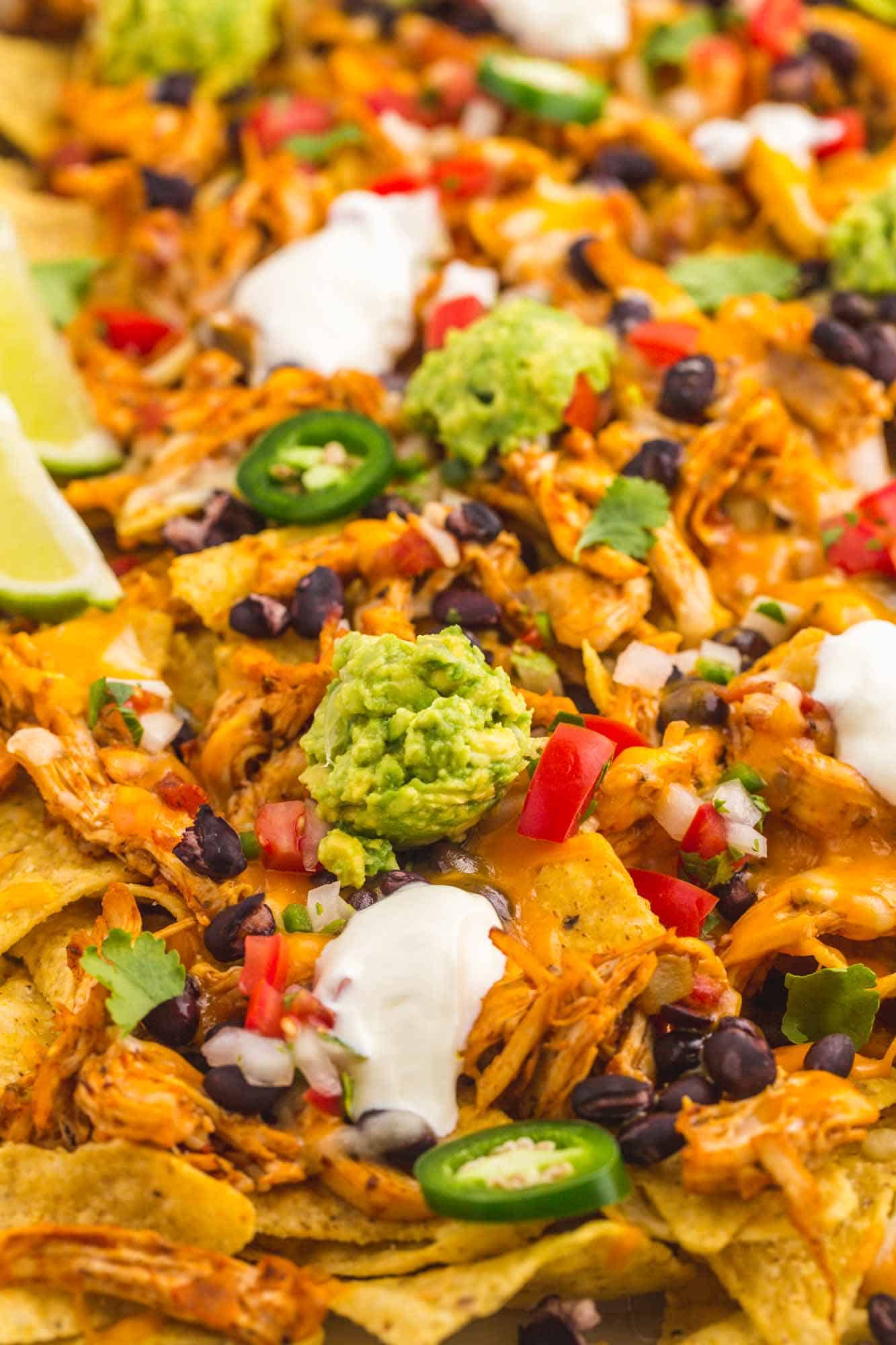 close up view of loaded nachos with chicken