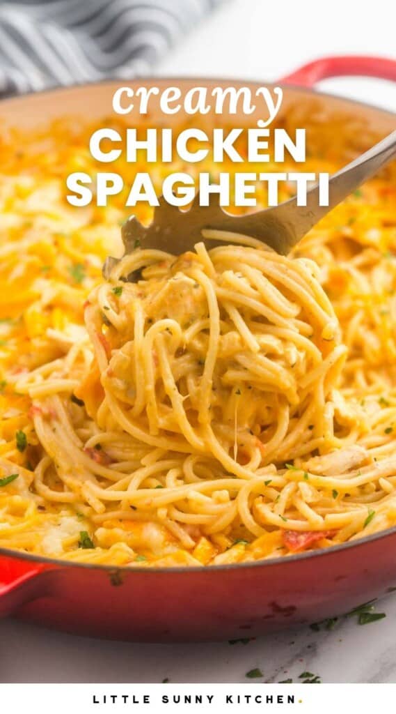 chicken spaghetti in a large red skillet, being served with a pasta spoon with text overlay that says creamy chicken spaghetti in all caps