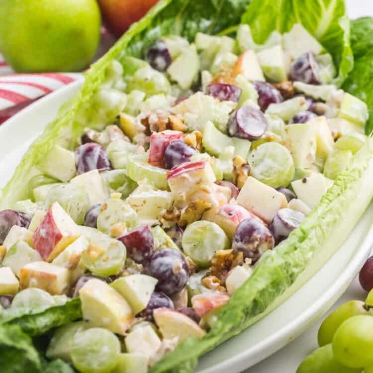 a romaine lettuce leaf filled with creamy waldorf salad.