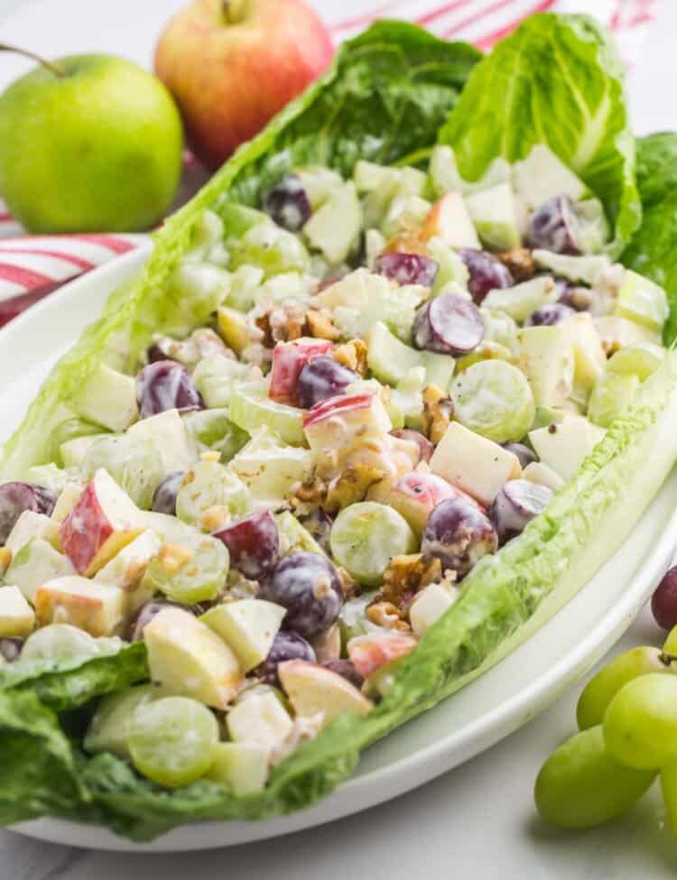 a romaine lettuce leaf filled with creamy waldorf salad.