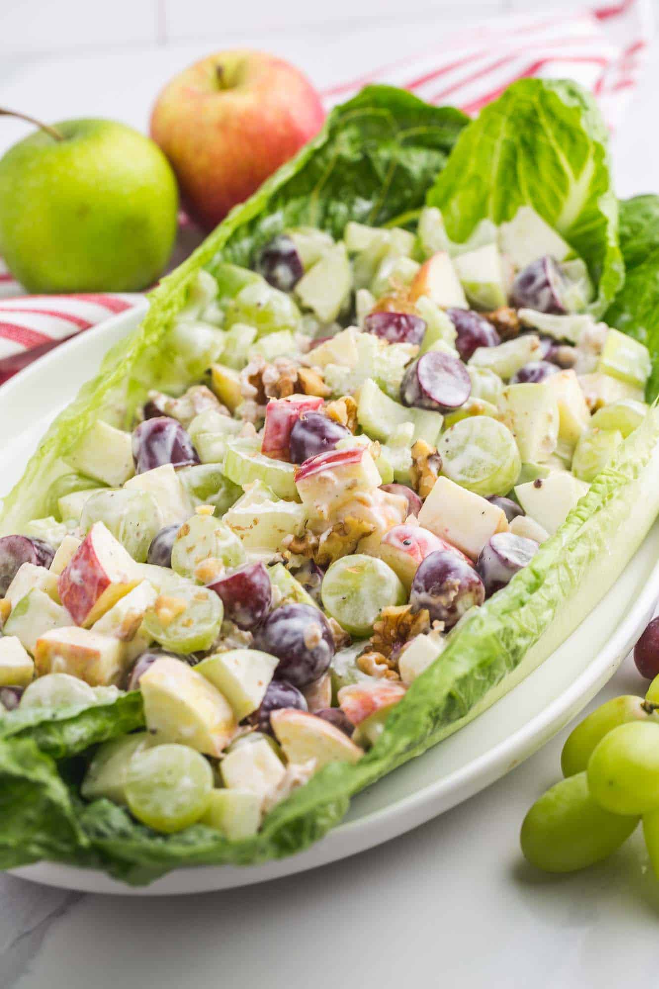 a romaine lettuce leaf filled with creamy waldorf salad. 