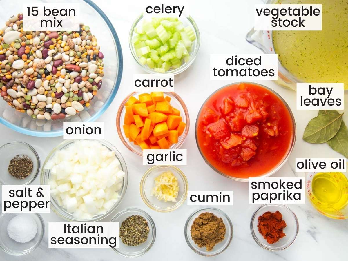 The ingredients needed to make 15 bean soup, measured into small bowls on a counter.