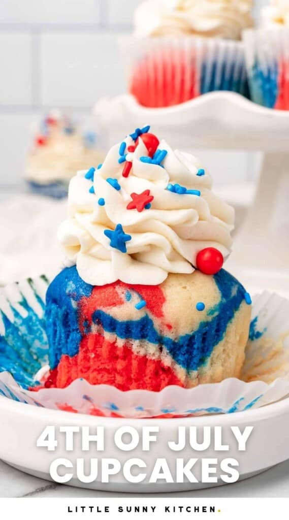a red white and blue tie dye cupcake, unwrapped, on a small plate.