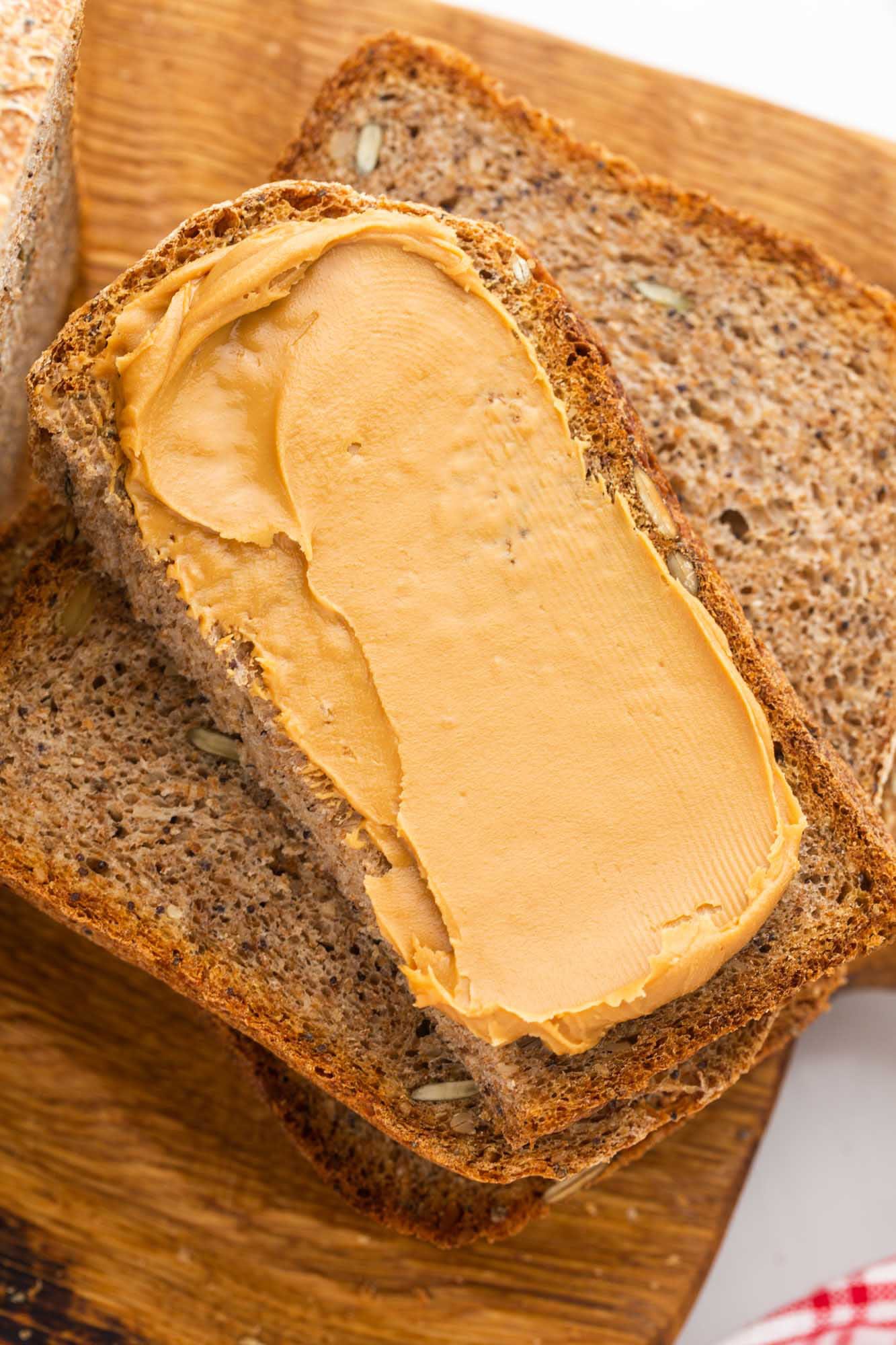 Seed bread slice with creamy peanut butter spread