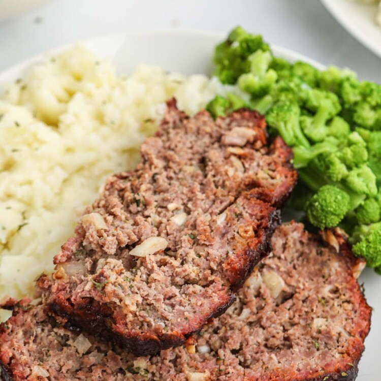 2 slices of smoked meatloaf with mashed potatoes and broccoli