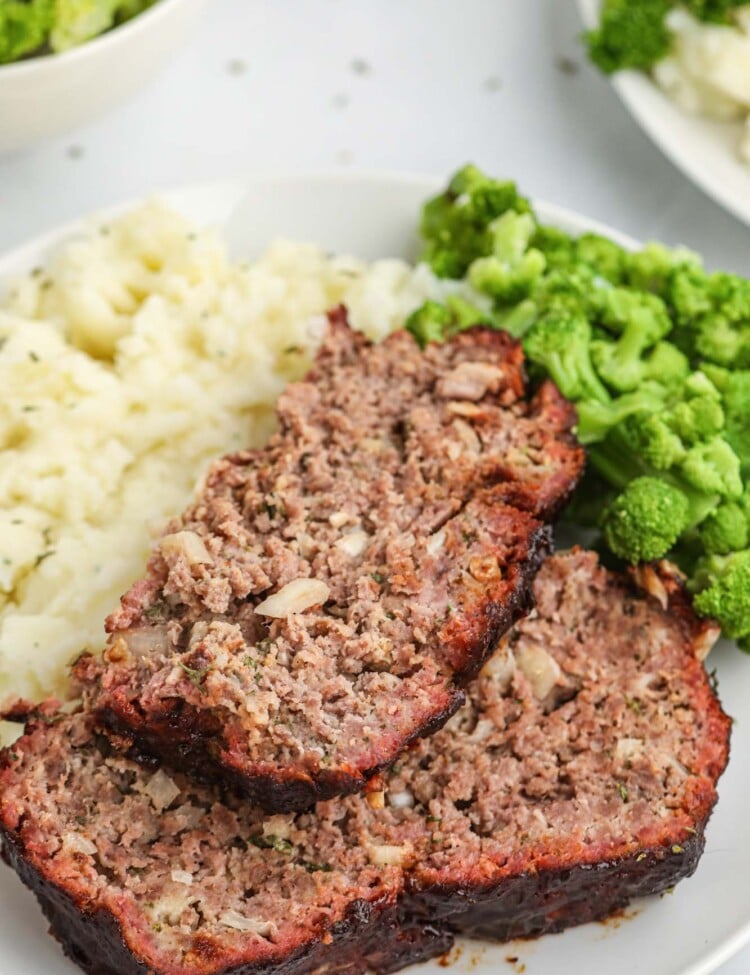 2 slices of smoked meatloaf with mashed potatoes and broccoli