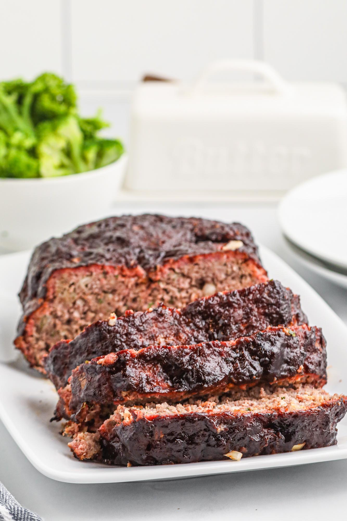 Sliced smoked meatloaf on a white plate