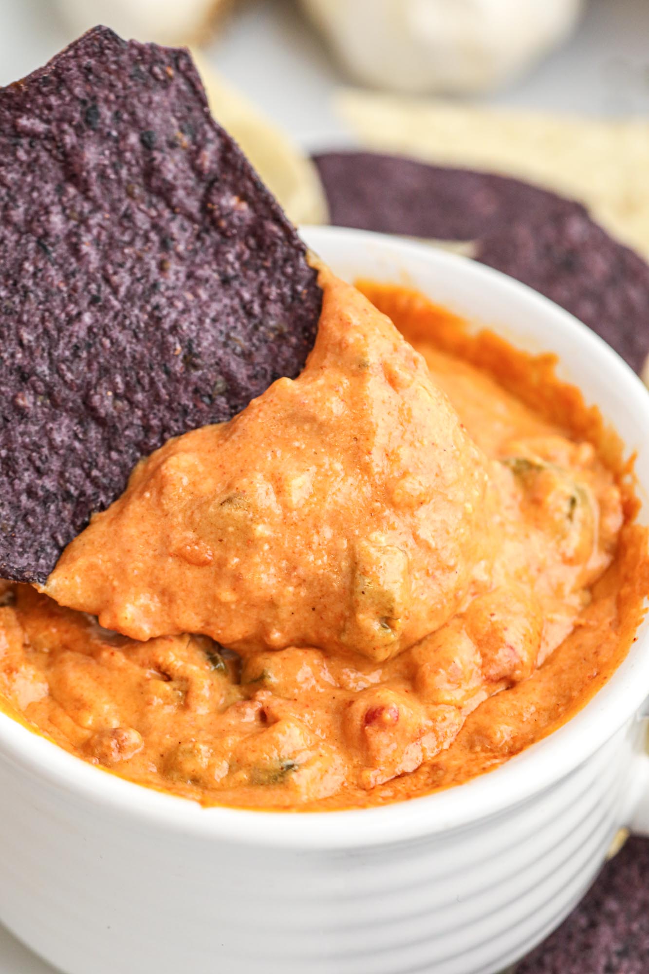 Dipping a tortilla chip in smoked queso