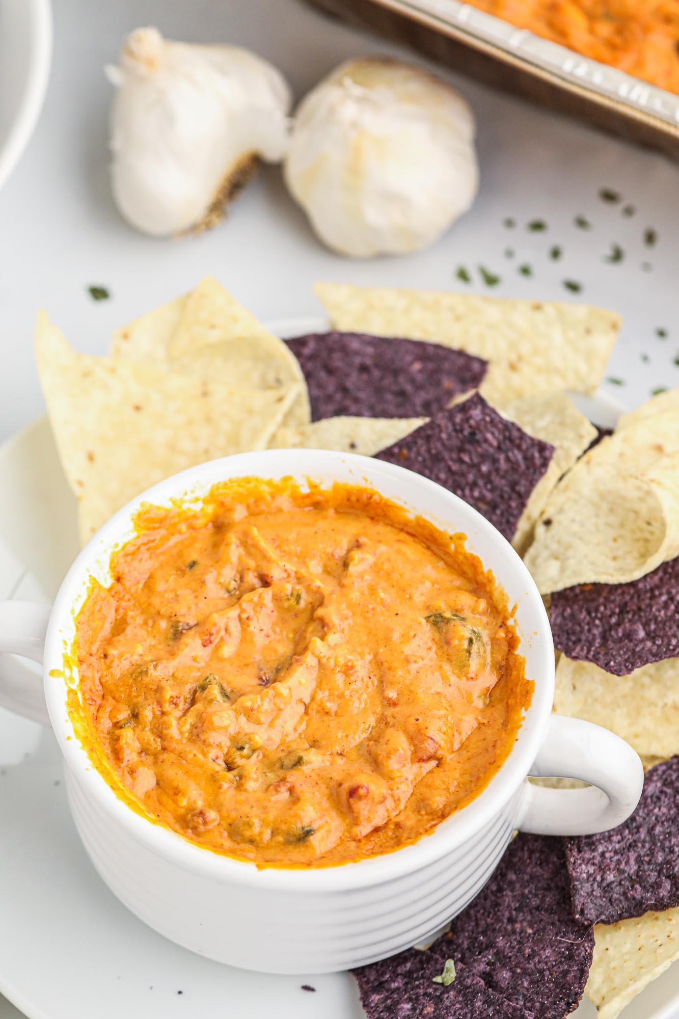 Smoked queso served in a bowl with tortilla chips on the side