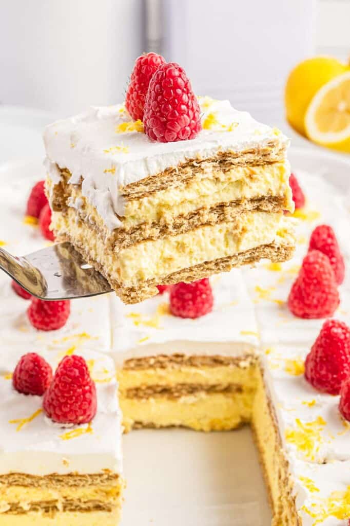 Taking a slice of lemon icebox cake from the pan