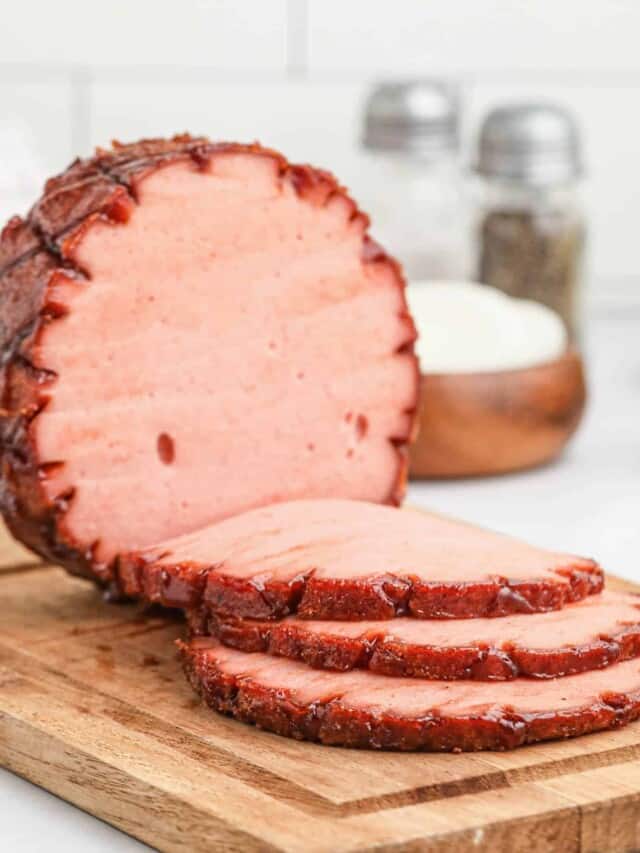 a large piece of bologna that has been smoked and sliced on a cutting board