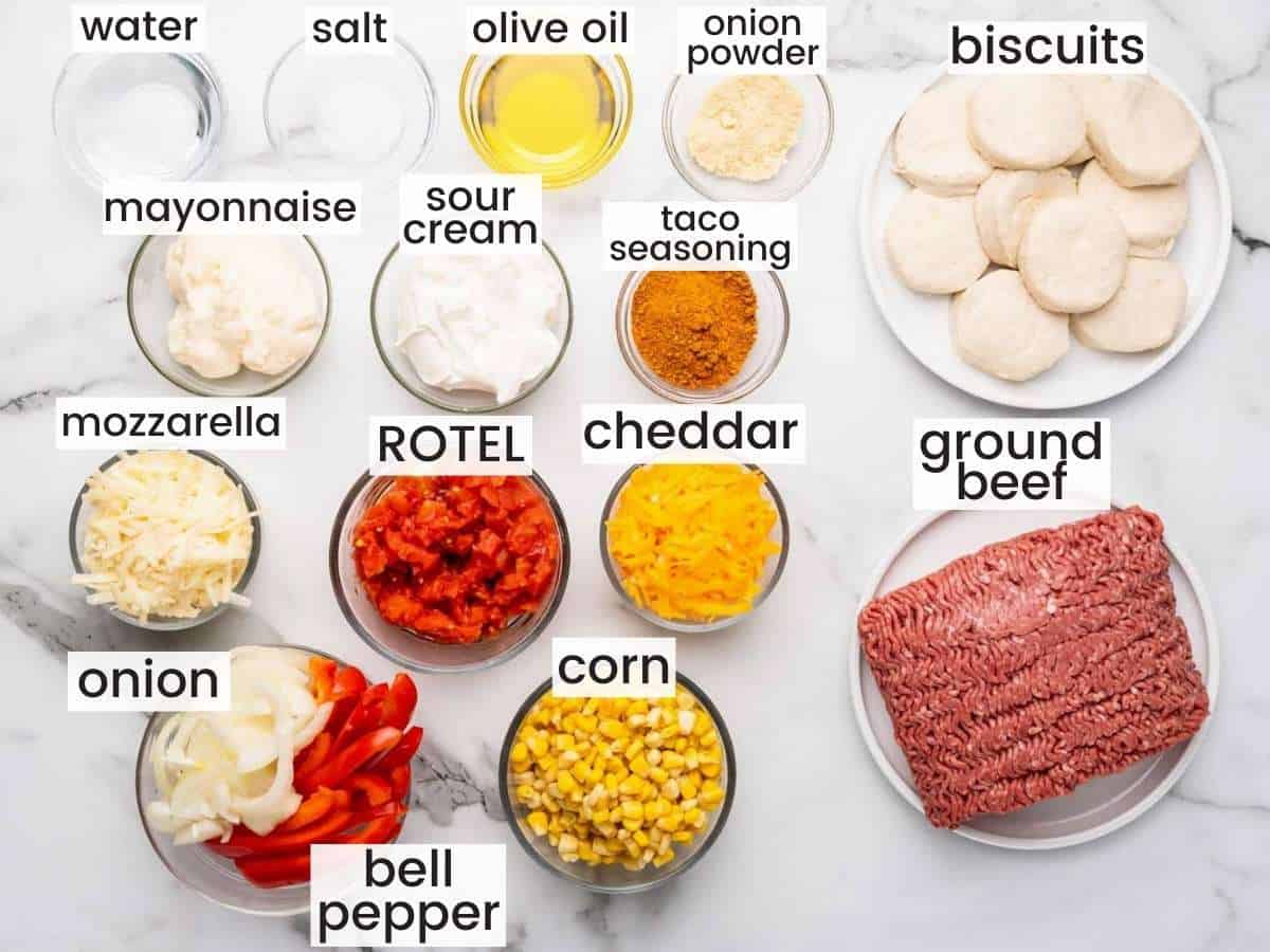 the ingredients for john wayne casserole, measured into bowls and placed on a marble counter. Text overlay labels each ingredient.