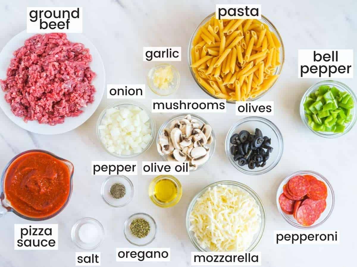 The ingredients need to make pizza casserole, all measured into small bowls and laid out on the counter, labeled with text overlay
