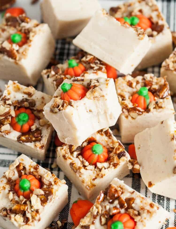 Overhead shot of fudge pieces with pumpkin candies, and a bite shot.