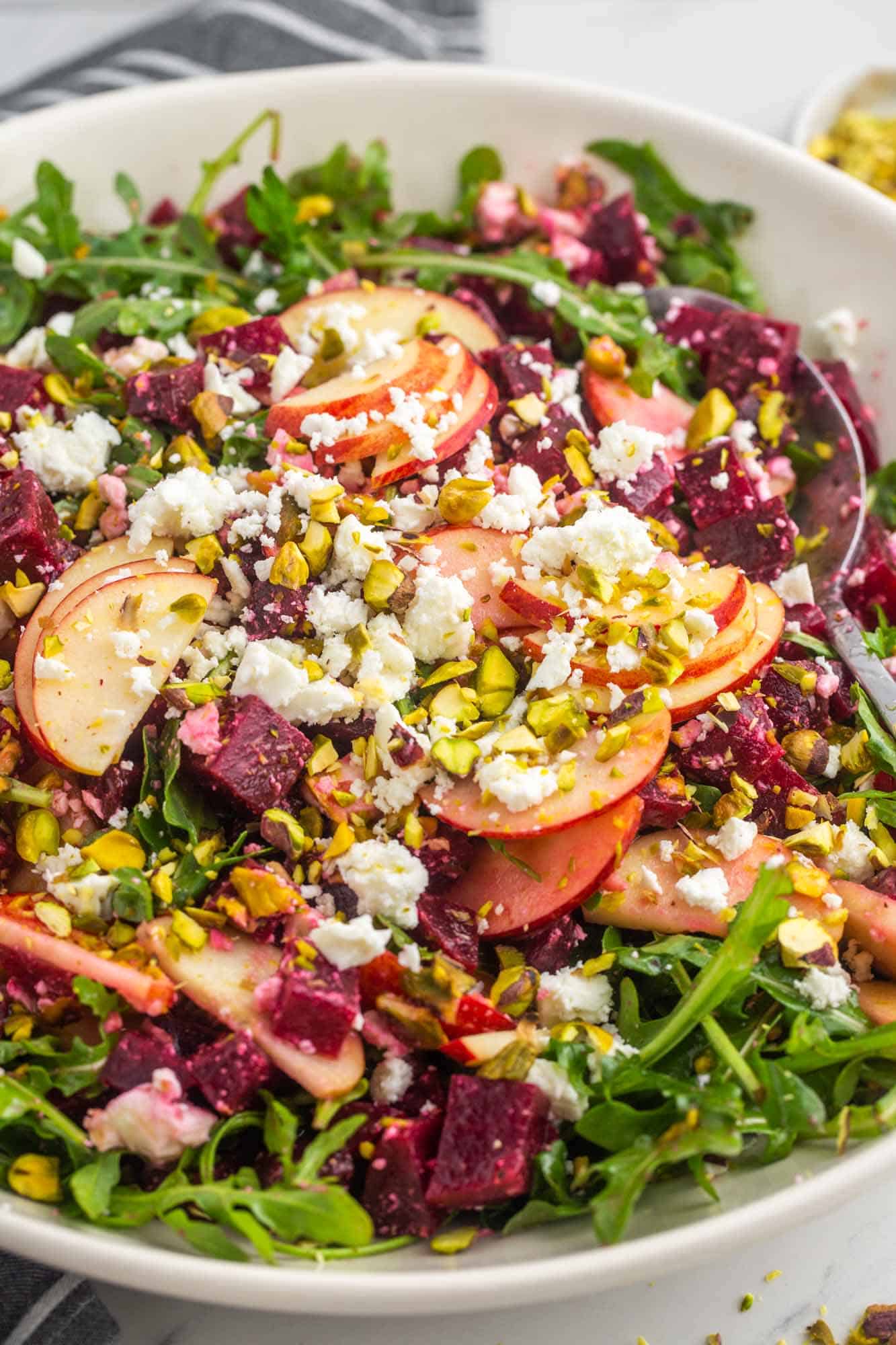 Beet Salad with apple slices, arugula, pistachio, and crumbled feta.