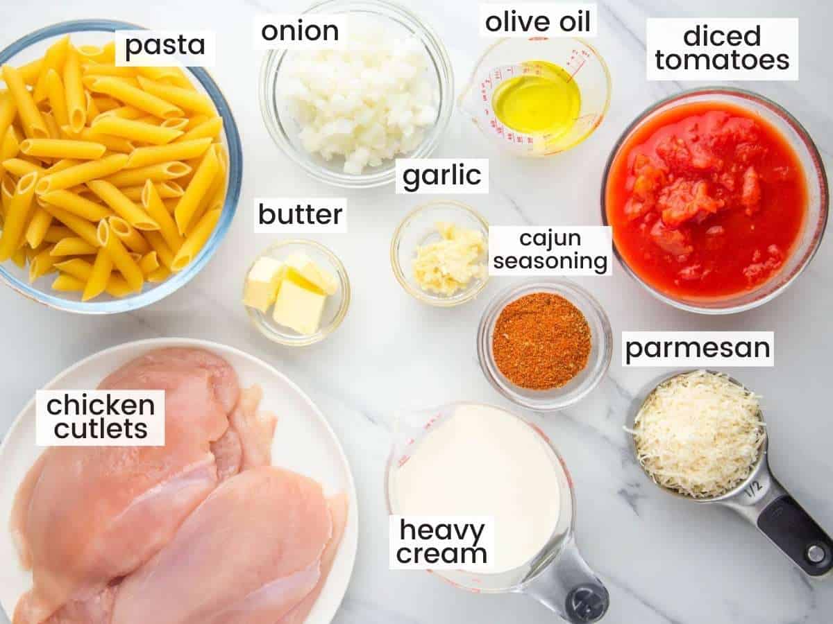The ingredients in cajun chicken pasta, alli n separate bowls and labeled with text overlays