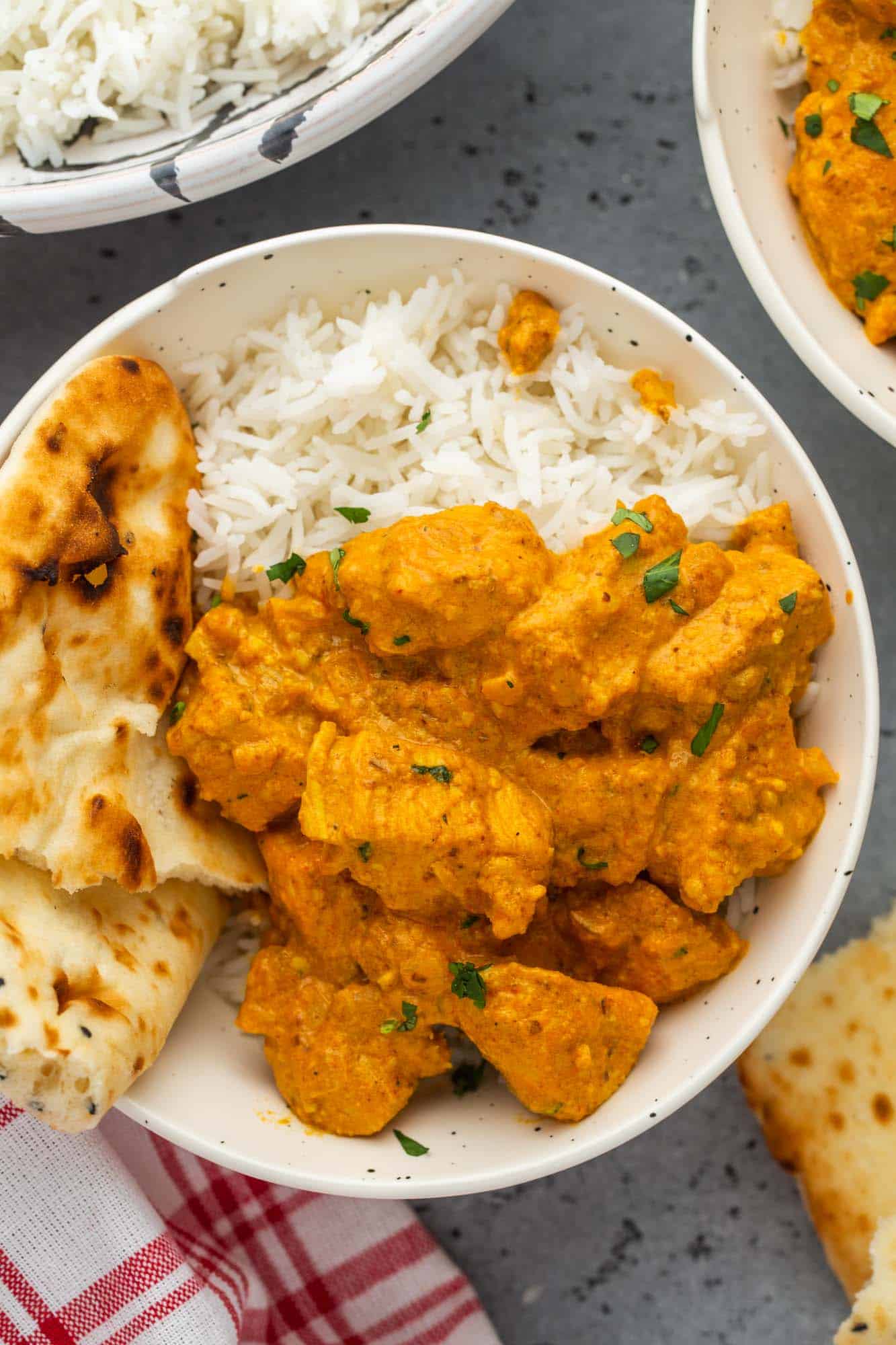 a bowl of rice topped with creamy chicken korma. 