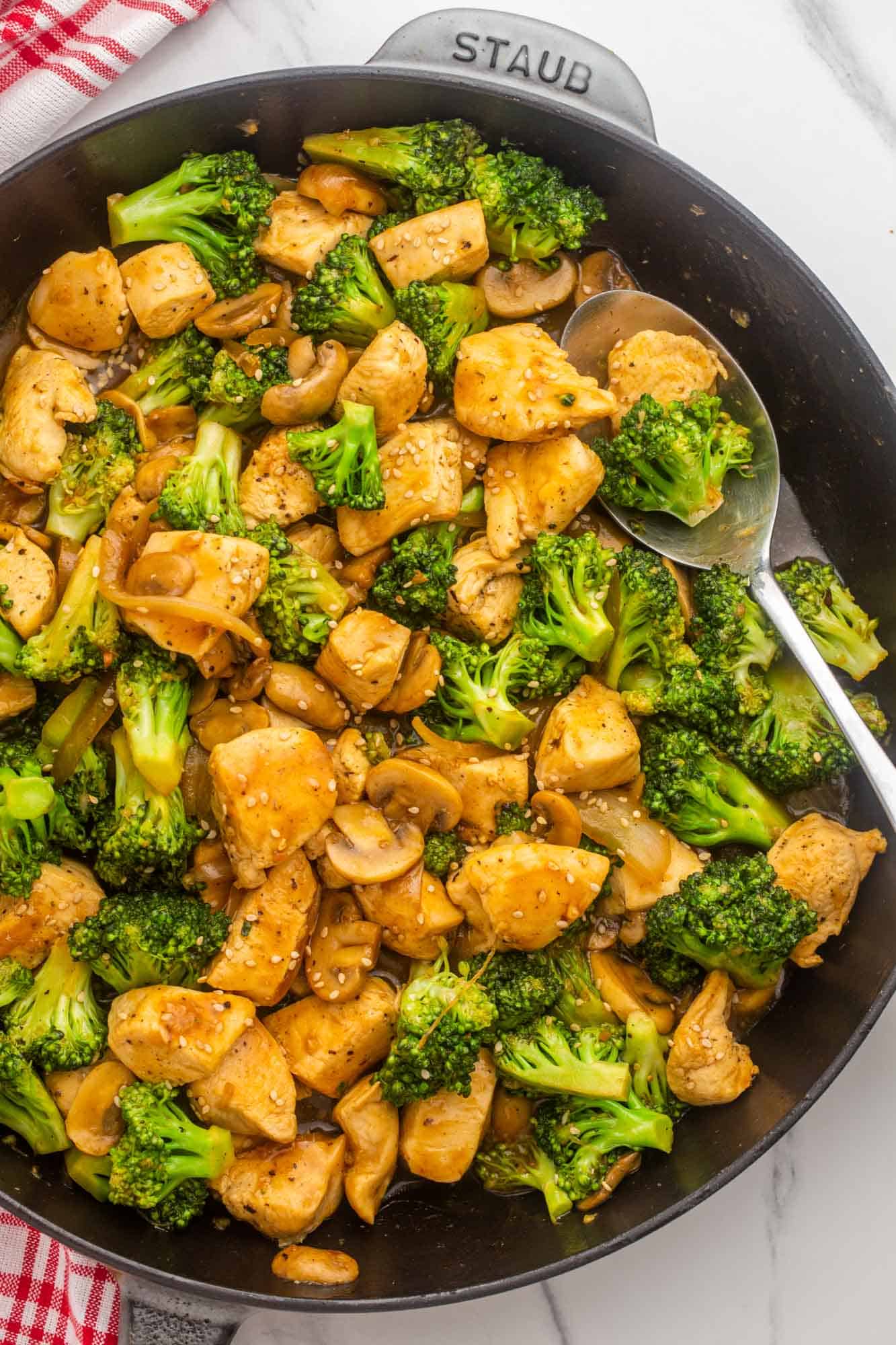 finished chicken and broccoli stir fry in a cast iron skillet. 
