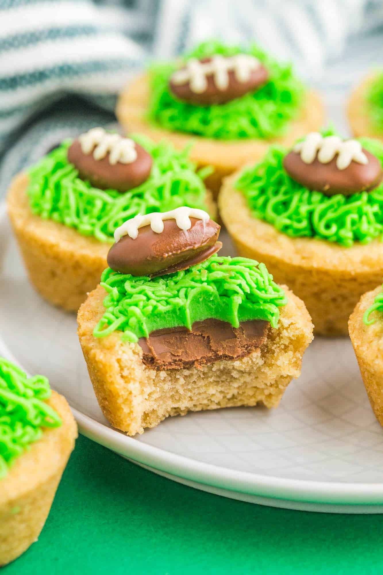 A bite shot of football cookie cups on a plate