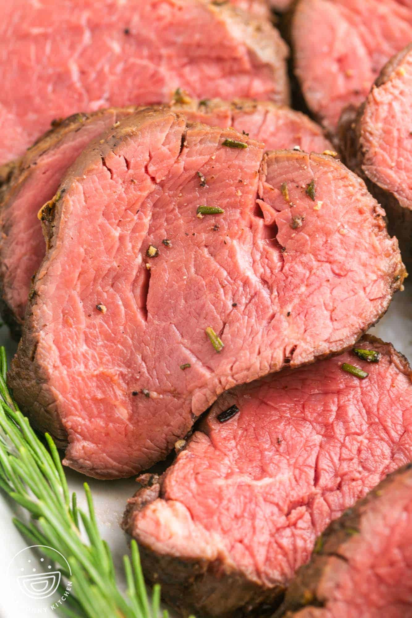 Close up shot of a slice of perfectly cooked beef tenderloin