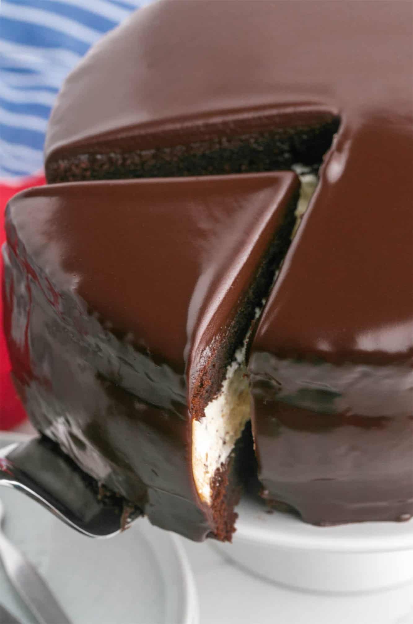 a slice of chocolate ding dong cake lifted away from the whole round cake.